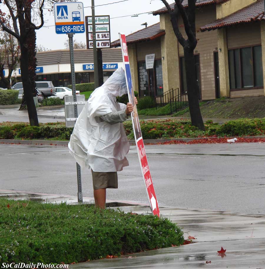 Sign man working in the rain